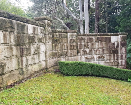 Before - sandstone wall softwashing pressurewashing